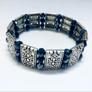 Stretch Bracelet with Silver Tone Filigree Accents & Purple Faceted Beads
